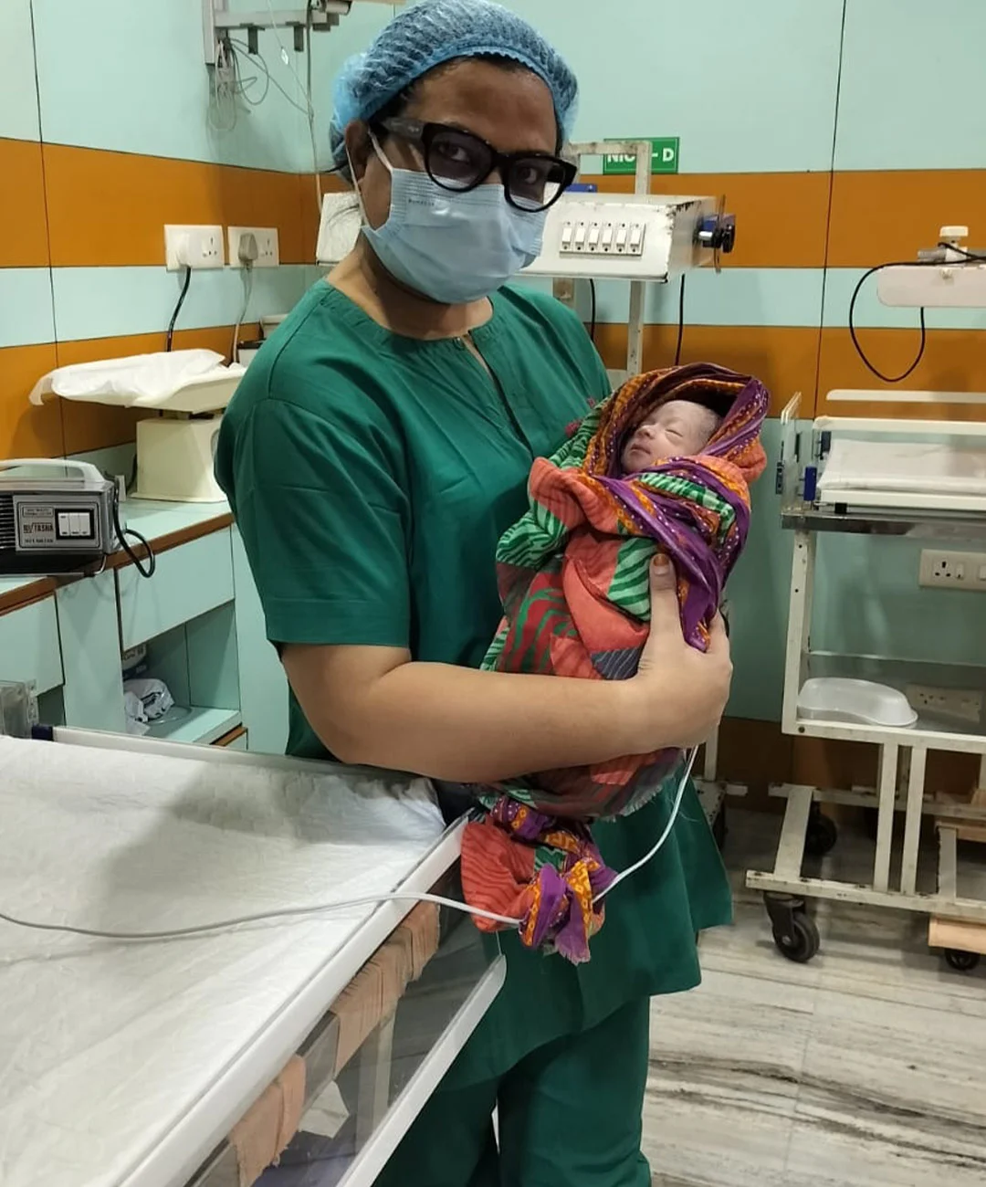 Dr. Neelam Singla holding a newborn baby
